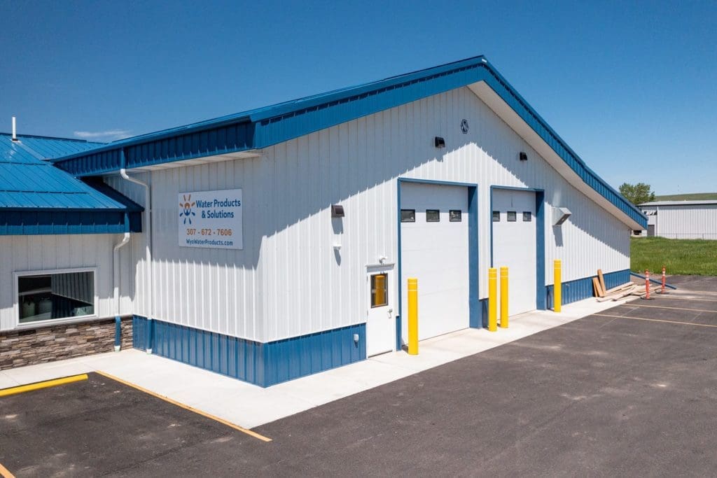 Exterior view of Water Products and Solutions with commercial sectional garage doors in Sheridan, Wyoming.