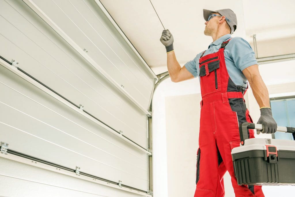 Inspection and Installation of white Residential Garage Door.