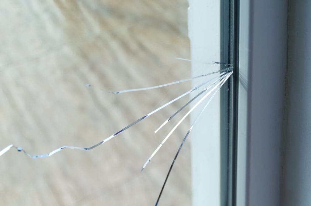 Cracked glass window in home.