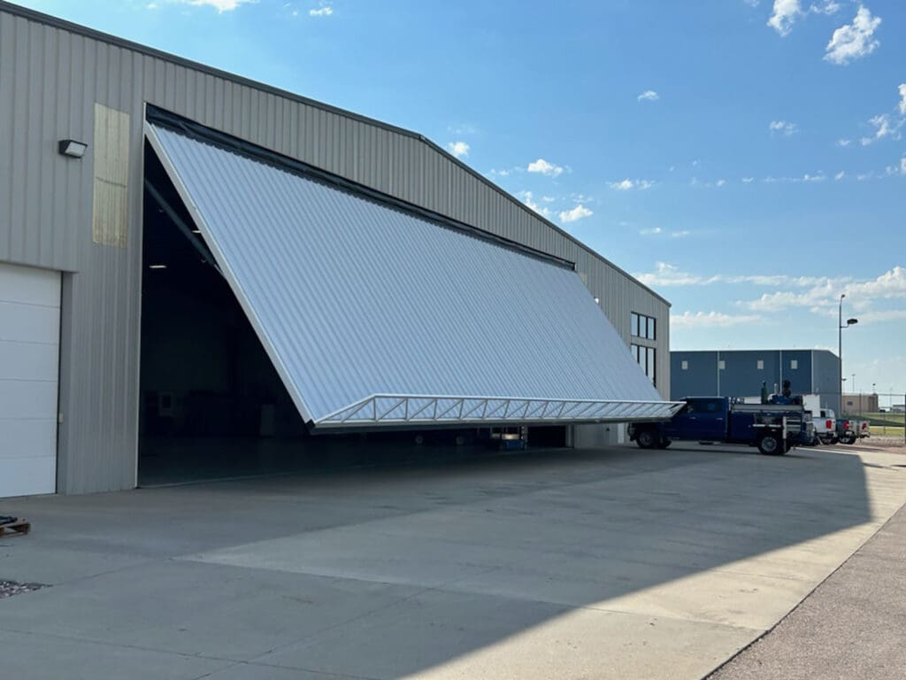 White commercial PowerLift door in process of lifting up