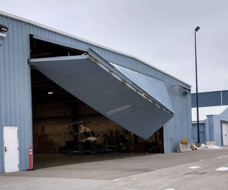 Damaged airplane hangar garage door