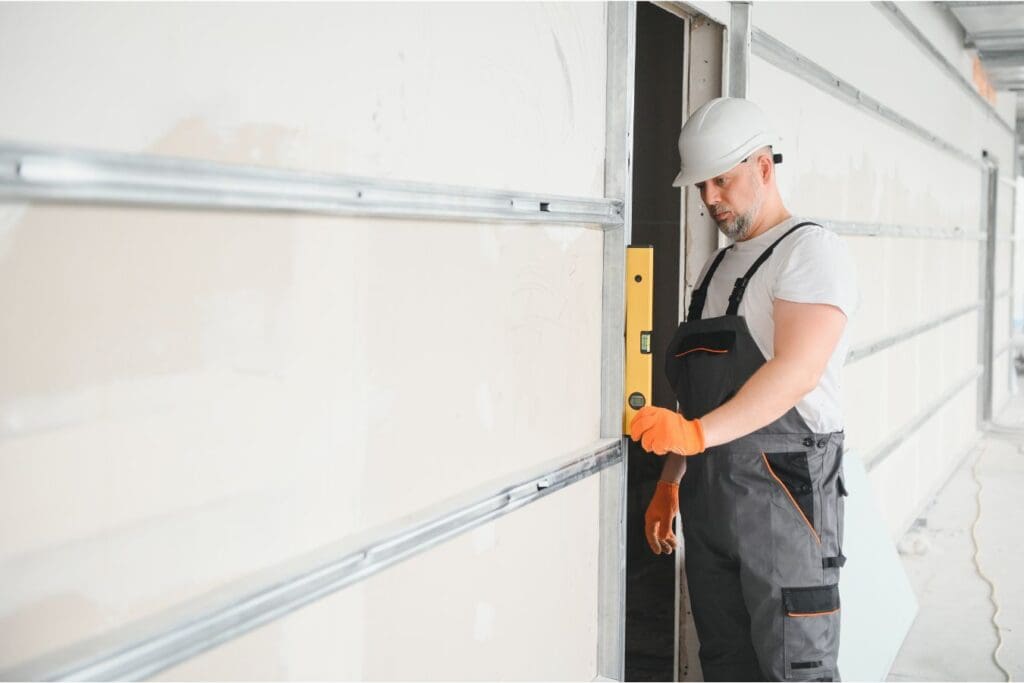 man installing garage door