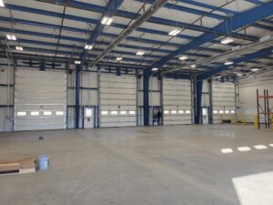 Inside of a commercial garage, showing several bays of garage doors.