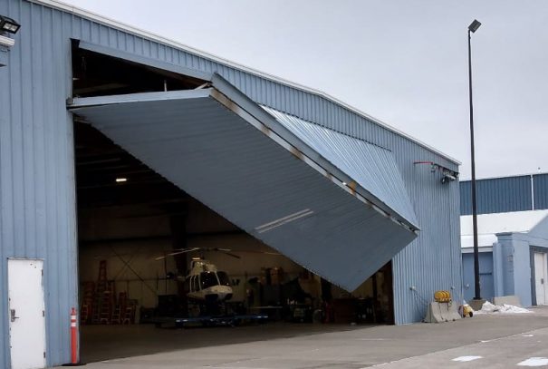 Damaged airplane hangar garage door