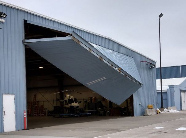 Damaged airplane hangar garage door