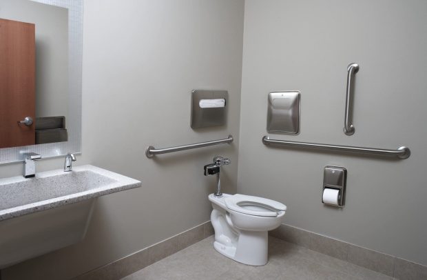 Toilet, handicap rail, toilet paper dispenser, and sink with mirror Toilet, handicap rail, toilet paper dispenser, and sink with mirror