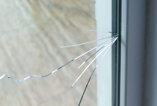 Crack on the glass at a residential house Cracked glass window in home.